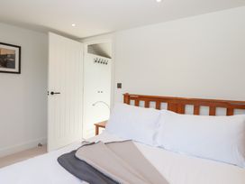 A bedroom with a bed and wardrobe doors at Clova in Brixham