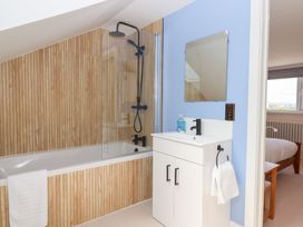 A bathroom with a bathtub and sink at Clova in Brixham