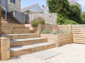 Steps leading to a garden area with plants and gravel at Clova in Brixham