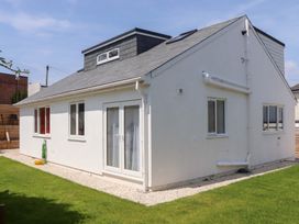 A house with windows and door in an outdoor setting at Clova Brixham