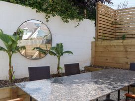An outdoor dining area with a table and chairs at Clova in Brixham