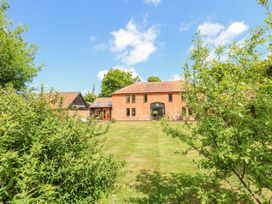 A house with a garden and trees at Lakeside Barn Aylsham