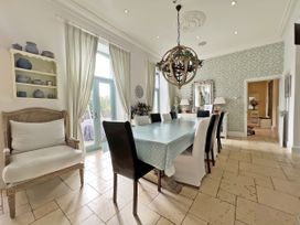 A dining room with a large table and chairs at Trenare in Truro