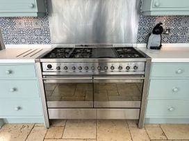 A stove with an oven and coffee maker at Trenare in Truro