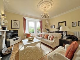 A living room with a sofa and coffee table at Trenare in Truro