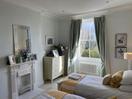 A bedroom with two beds and a window at Trenare in Truro