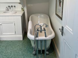 A bathroom with a bathtub and sink at Trenare in Truro
