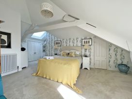 A bedroom with a bed and bedside table at Trenare in Truro