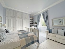 A bedroom with two beds and a crib at Trenare in Truro