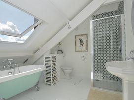 A bathroom with a bathtub, shower, toilet, and sink at Trenare in Truro