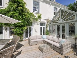 A garden seating area with sofa and table at Trenare in Truro