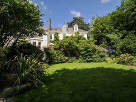 A garden with a house in the background at Trenare in Truro