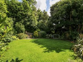A garden with grass and trees at Trenare in Truro