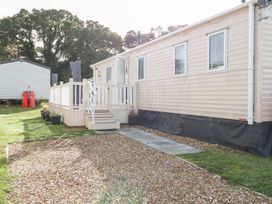An outdoor area with a mobile home and deck at Number 34 Foxburrow Hang Great Yarmouth