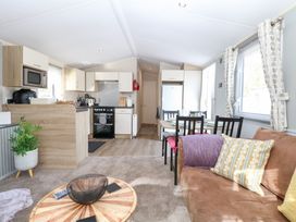 A living room with a kitchen and dining area at Number 34 Foxburrow Hang in Great Yarmouth