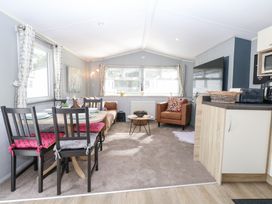 A living room with a dining table and sofa at Number 34 Foxburrow Hang Great Yarmouth