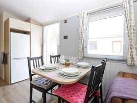 A dining area with a table and chairs at Number 34 Foxburrow Hang in Great Yarmouth