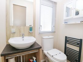 A bathroom with a wash basin and toilet at Number 34 Foxburrow Hang in Great Yarmouth