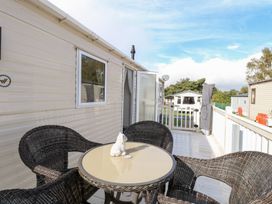 An outdoor seating area with a table and chairs at Number 34 Foxburrow Hang in Great Yarmouth