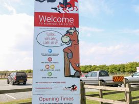 A welcome sign with horse illustration at Redwings Caldecott in Great Yarmouth