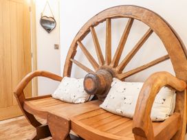 A wooden bench designed like a wheel at Perth Y Deri Llanddwywe