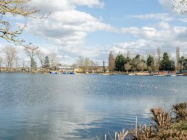 A lake with floating inflatable water park and trees in the background at Meadowview Billing Aquadrome in Billing Aquadrome Holiday Park
