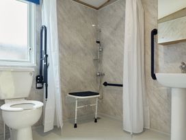 A bathroom with toilet, sink, and shower at Meadowview - Billing Aquadrome