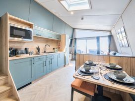 A kitchen and dining area with table settings and large window at Skylight Stargazer - Billing Aquadrome in Billing Aquadrome Holiday Park