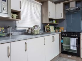 A kitchen with oven and sink at Sandy Shores - Hayling Island