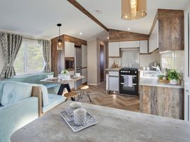 A kitchen with seating area and appliances at Island Breeze - Hayling Island