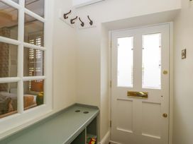 An entrance hall with a door and coat hooks at The Cottage in Stow-On-The-Wold