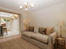 A living room with a sofa and lamp at The Cottage in Stow-On-The-Wold