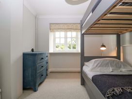 A bedroom with a bunk bed and drawer unit at The Cottage Stow-On-The-Wold
