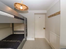 A bedroom with a bunk bed and a door at The Cottage in Stow-On-The-Wold