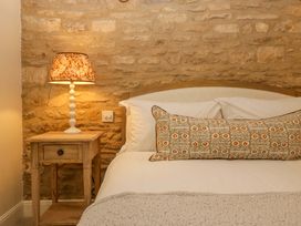 A bedroom with a bed and bedside table at The Cottage in Stow-On-The-Wold