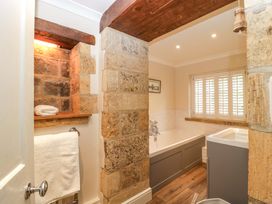 A bathroom with a bathtub and sink at The Cottage Stow-On-The-Wold