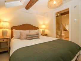 A bedroom featuring a bed and access to a bathroom at The Cottage in Stow-On-The-Wold
