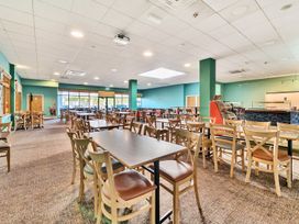 A dining room with tables and chairs at Golden Dune - Hayling Island