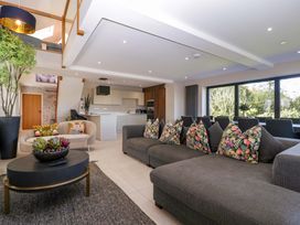 A living room with a sofa and coffee table at Forest Lodge in Pontyclun