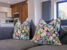A living room with cushions on a sofa at Forest Lodge in Pontyclun