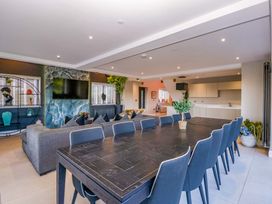 A dining room with a table and chairs at Forest Lodge in Pontyclun