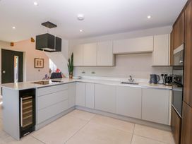 A kitchen with modern appliances at Forest Lodge in Pontyclun
