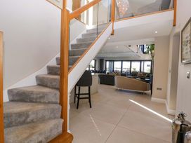 A staircase leading to the living room at Forest Lodge in Pontyclun