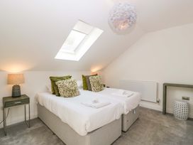 A bedroom with beds and lamps at Forest Lodge in Pontyclun
