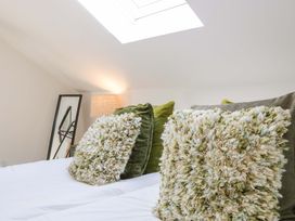 A bedroom with pillows and a lamp at Forest Lodge in Pontyclun