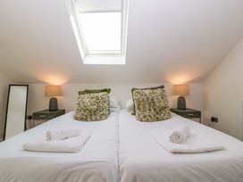 A bedroom with beds and lamps at Forest Lodge in Pontyclun