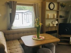 A dining area with a table and sofa at 38 The Green