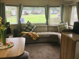 A living room with a couch and table at 38 The Green