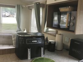 A kitchen with a Ninja appliance and microwave at 38 The Green