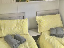 A bedroom with twin beds and towels at 38 The Green